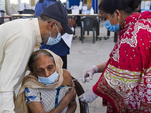 BBC Mundo: Una mujer recibe una dosis de la vacuna china Sinopharm en Pakistán.